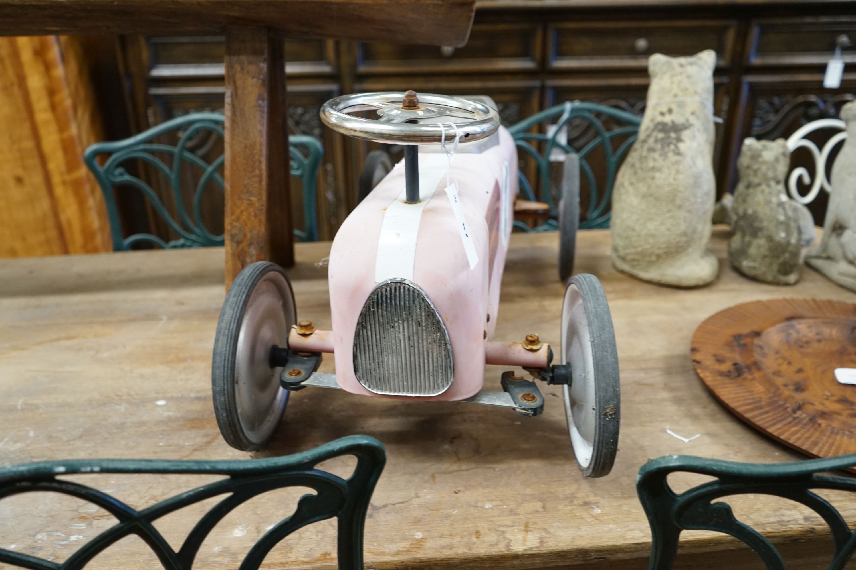 A child's sit-on toy racing car